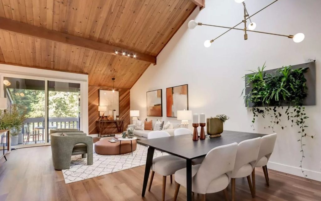 Spacious contemporary style living area with dramatic vaulted wood ceiling connecting to dining space