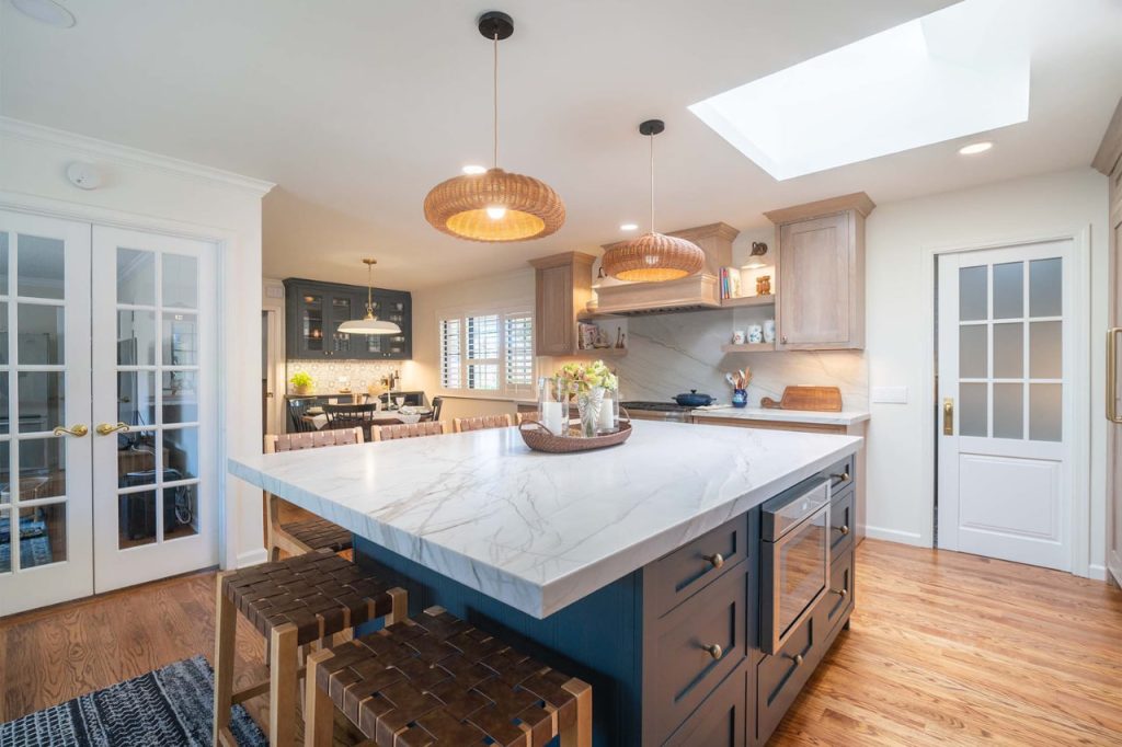 Contemporary custom kitchen cabinets Honolulu installation with large quartz island and wood pendant lighting